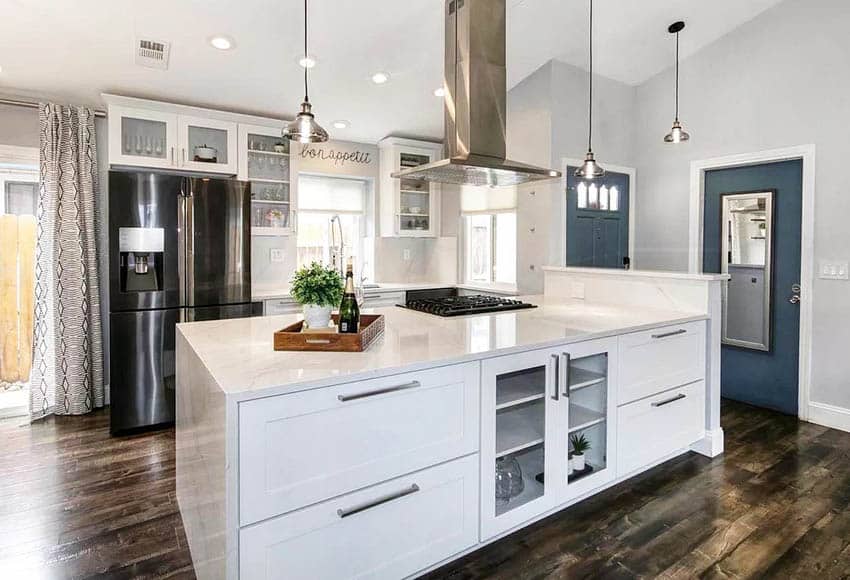 Open concept kitchen with silestone countertops waterfall island white cabinets dark wood flooring