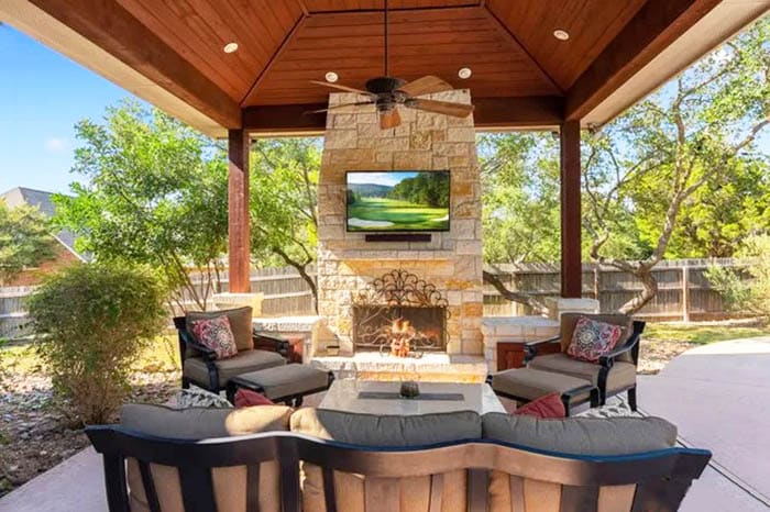Outdoor wood canopy with fireplace and outside waterproof tv