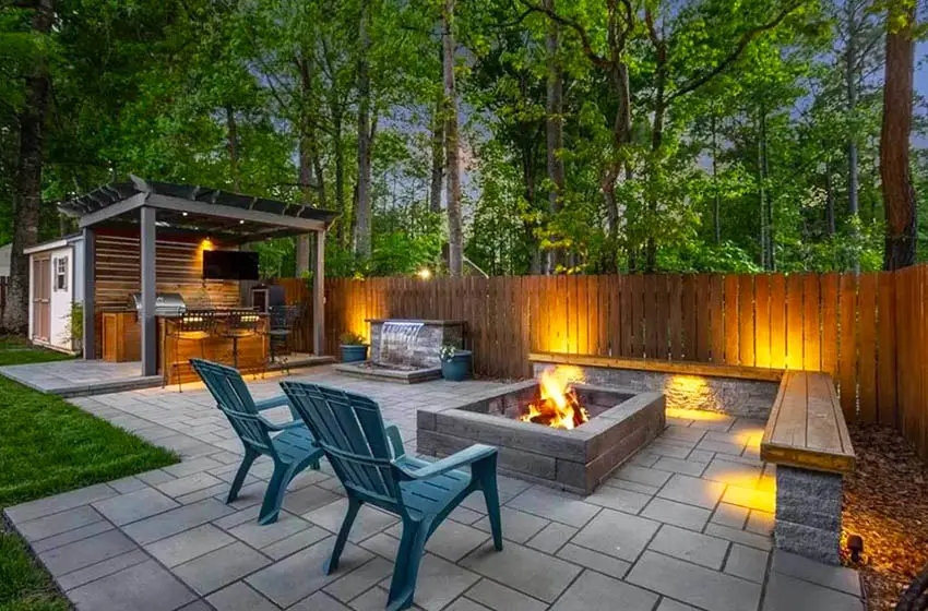 Paver patio with fire pit and outdoor tv under pergola
