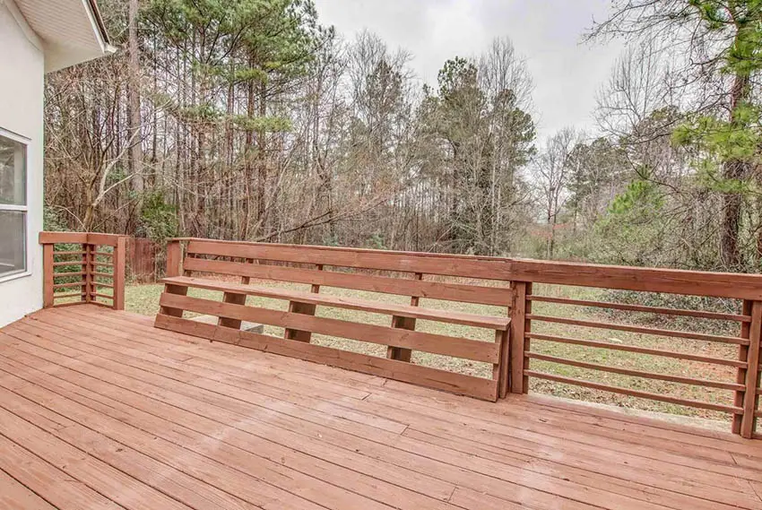 Rustic wood deck railing with bench