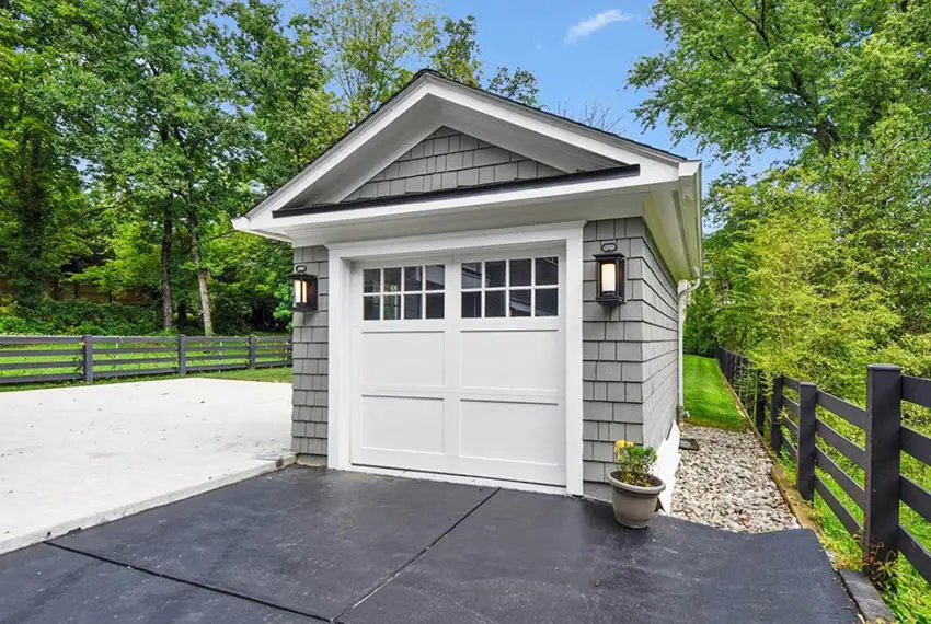 Small one car detached garage with gray paint white trim shingle siding