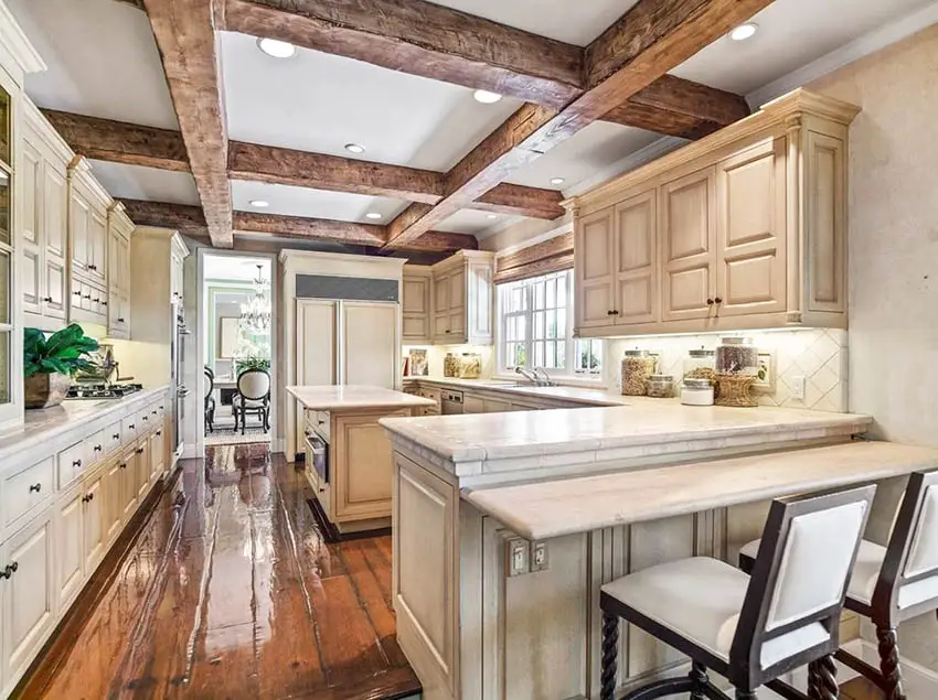 Traditional kitchen with island and peninsula wood beams and wood flooring