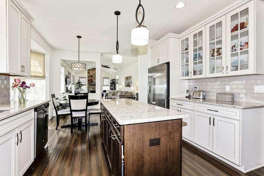 Traditional kitchen with silestone countertops white cabinets wood island