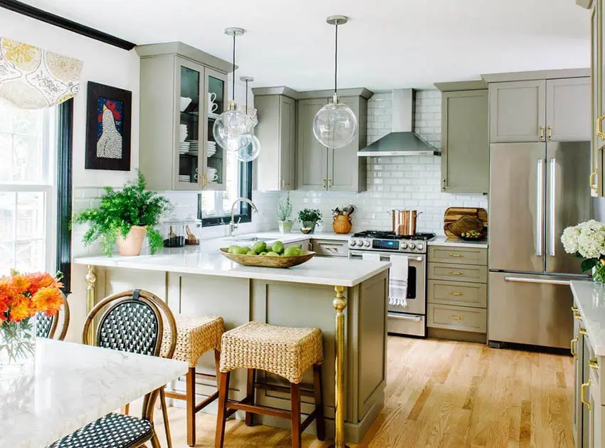 Kitchen with light green cabinets, French bistro chair and wicker stool chairs