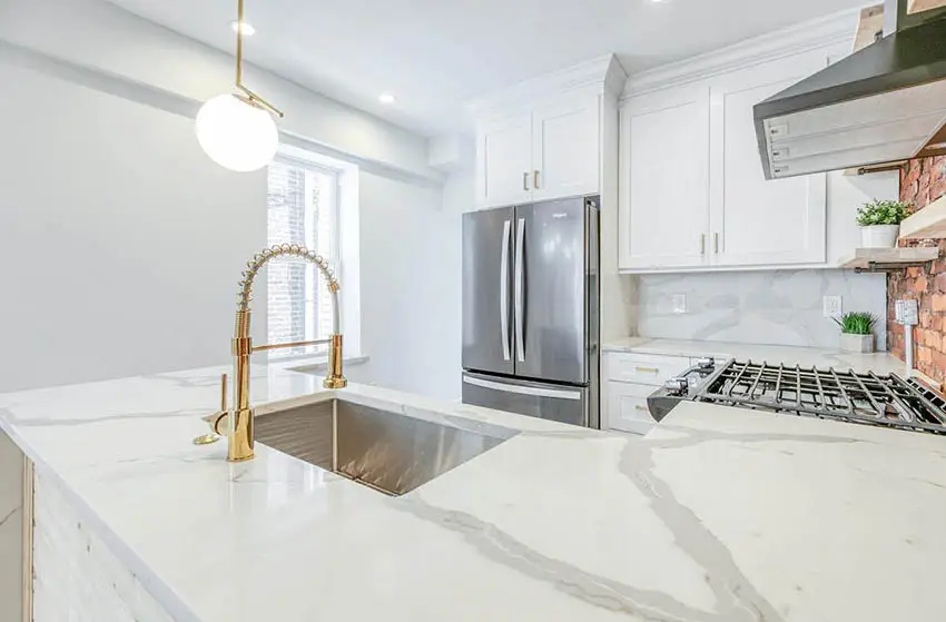 U shaped kitchen with calacatta quartz countertop white cabinets