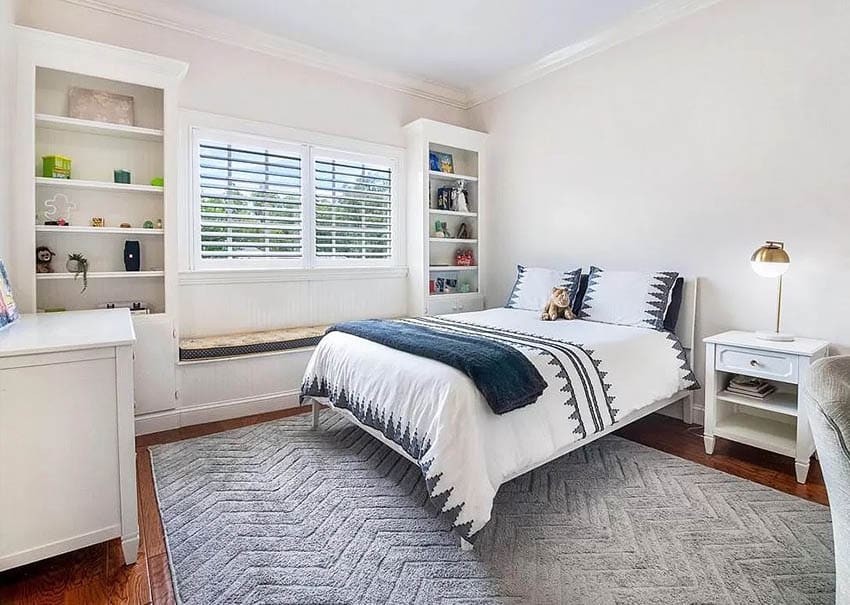 Bedroom with custom built ins with shelves and center window seat