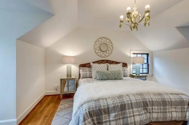 Cape cod style home upstairs bedroom with chandelier