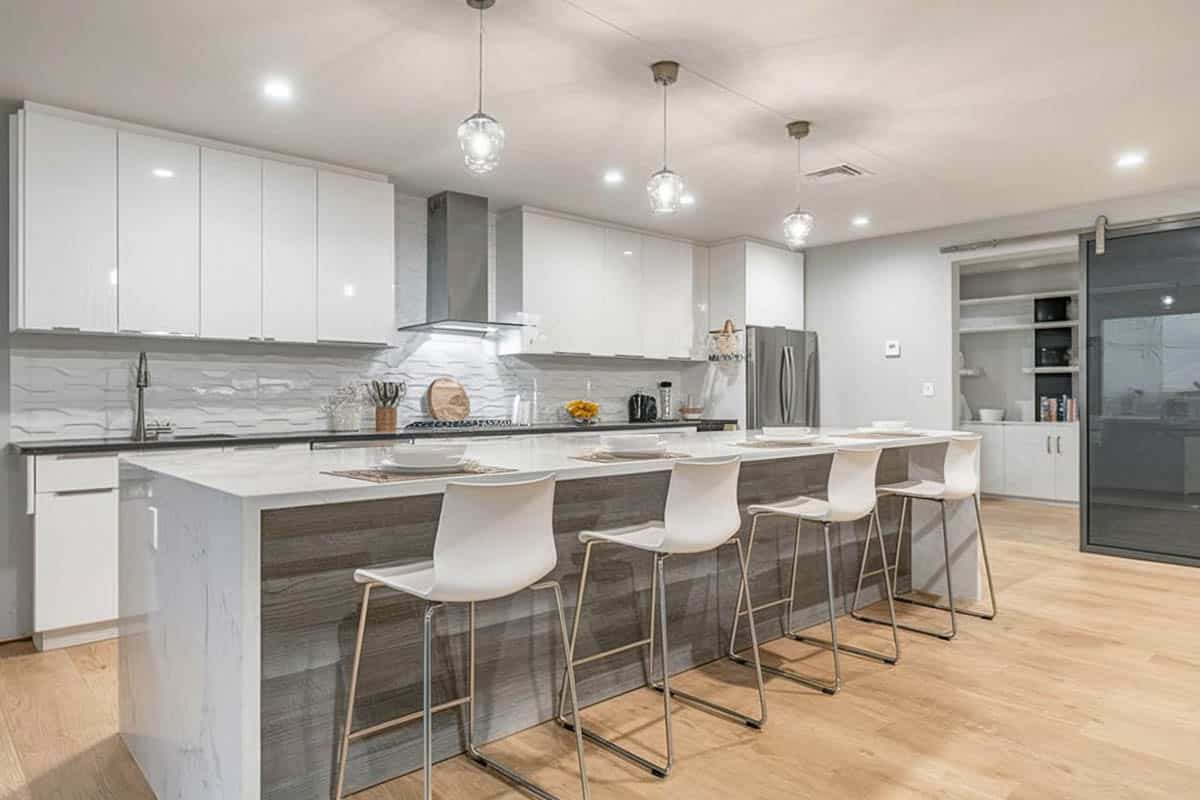 Glossy cabinets and contrasting reclaimed wood island