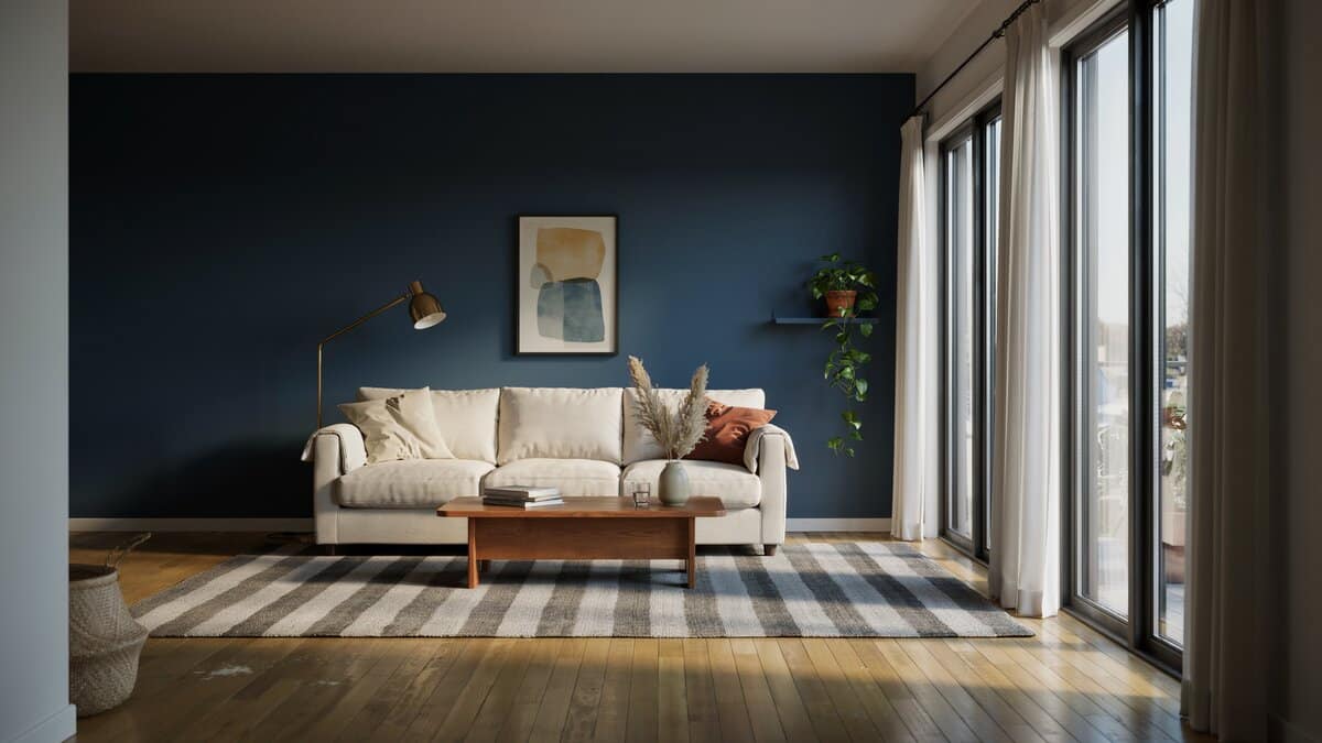 Contemporary living room with navy blue accent wall, striped rug, and sunlit windows