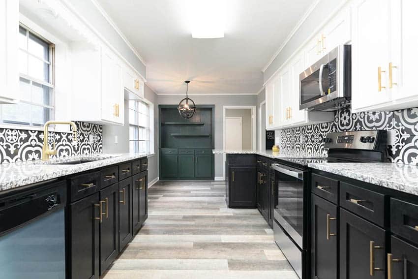 Galley kitchen with decorative tile backsplash and white upper cabinets