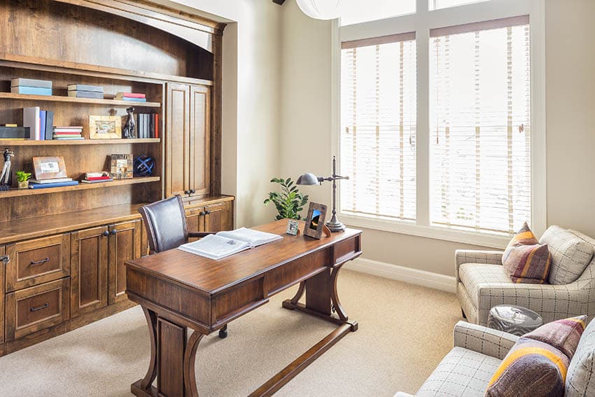 Office with broadloom carpet and wood built-in bookshelves