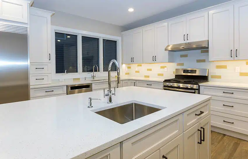 Kitchen with crushed glass countertops white cabinets