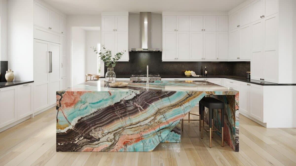 Kitchen island topped with exotic colorful quartzite and a stainless steel hood