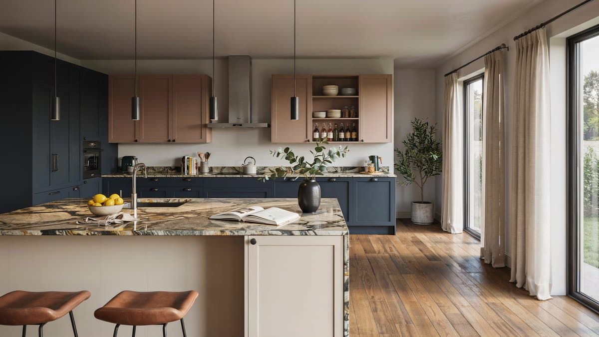 Kitchen with juparana vyara granite, navy and blush cabinets and a cream island