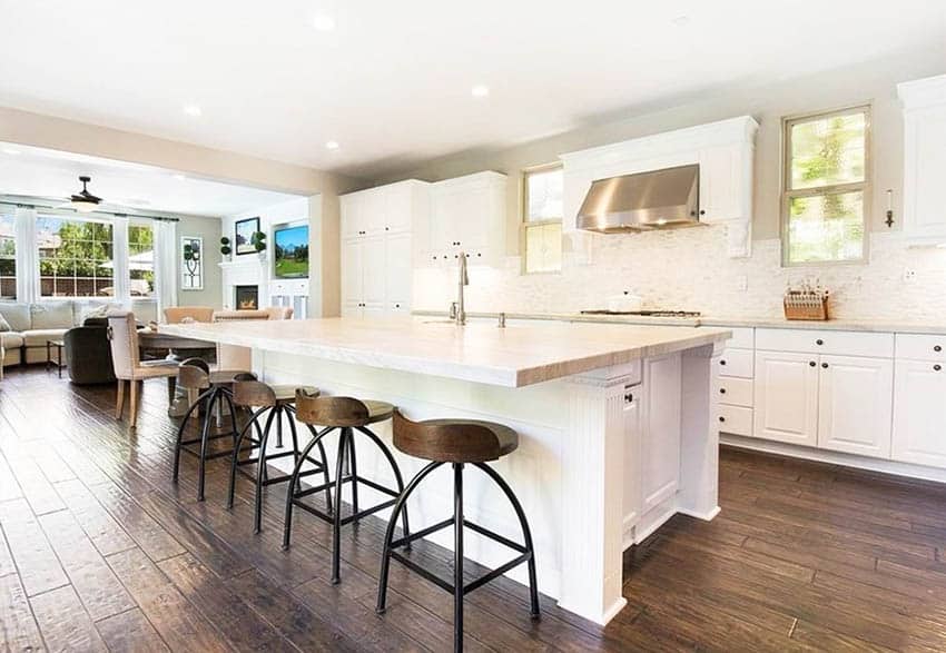 Kitchen with taj mahal quartzite counter, white cabinetry and hand scraped wood flooring