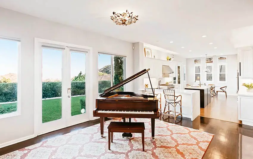 Living room with grand piano on area rug