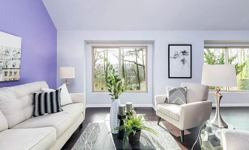 Living room with renovated painted purple accent wall and gray paint