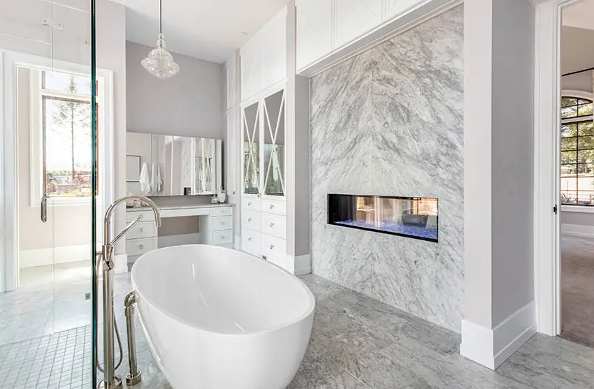 Bathroom with fireplace and white tub