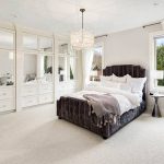 Master bedroom with built-in wardrobe with cabinets and drawers