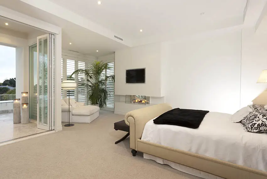 Bedroom with accordion door with louvered windows
