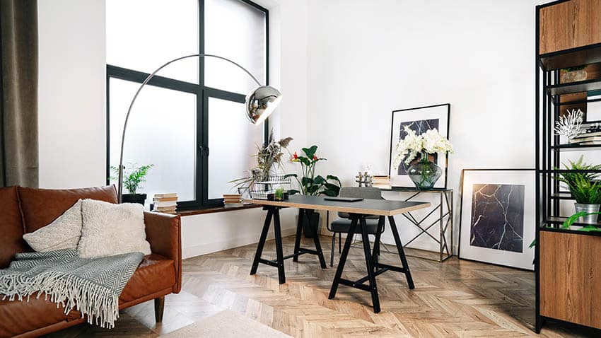 Modern home office with diy desk wood flooring and mid century modern lamp