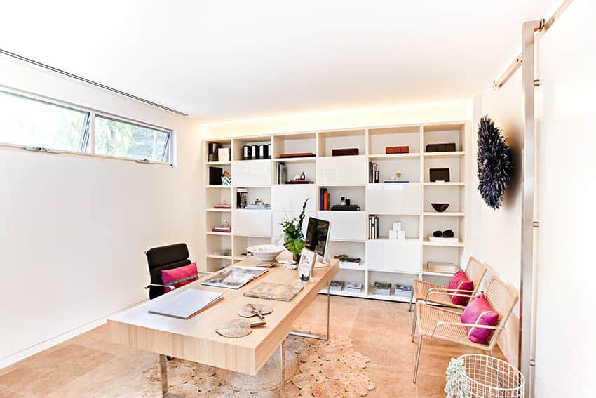 Modern office with limestone flooring wall of shelving