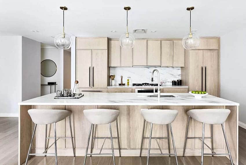 Kitchen with quartz, beige wood veneer cabinets and globe pendant lighting
