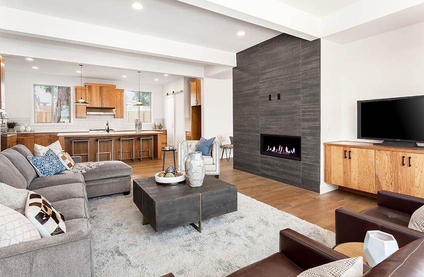 Open concept room with gray tile surround fireplace