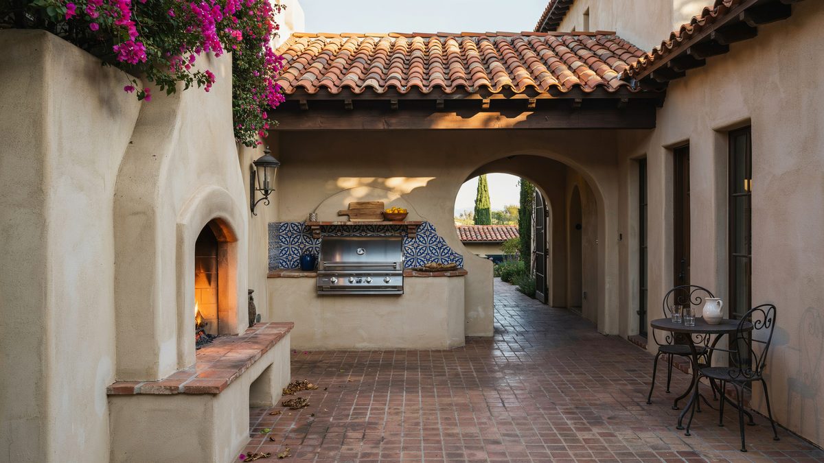 Spanish style stucco patio with corner fireplace built in grill and terracotta tile