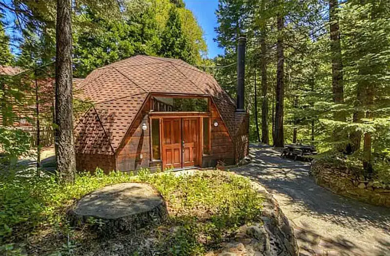 Wood geodesic home in forest