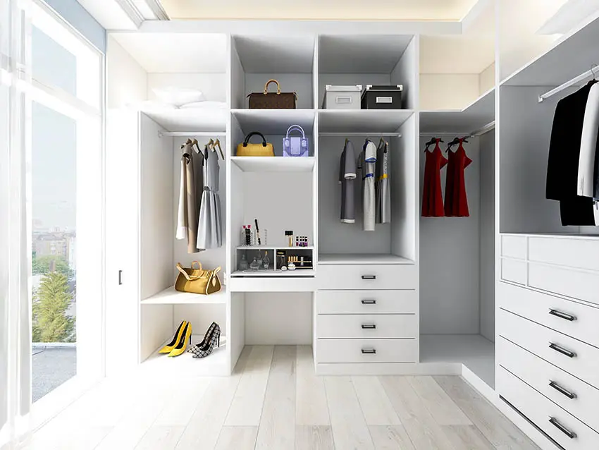 White closet with windows, dresses and spaces for handbags