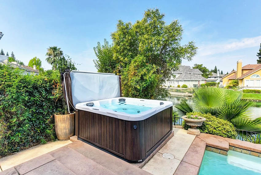 Backyard jacuzzi with waterfront canal view
