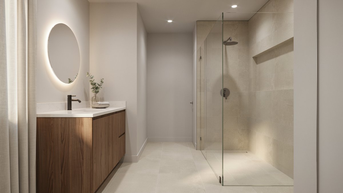Soft gray walls over beige floor tile with a glass walk-in shower