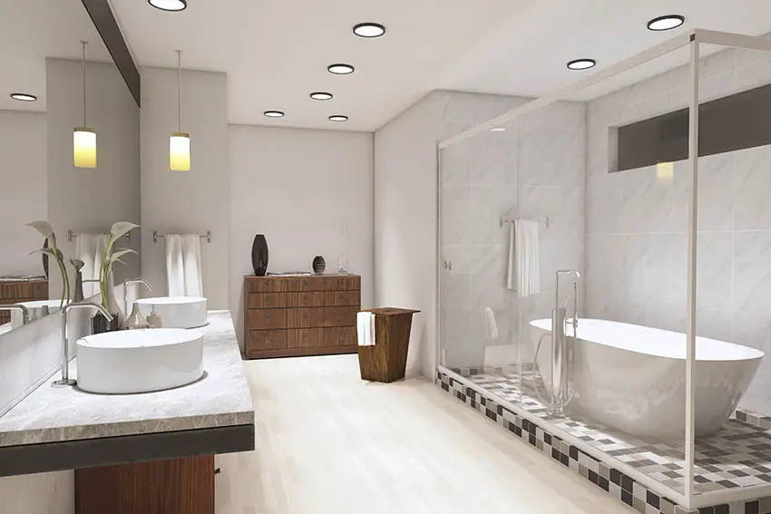 Bathroom with beige floor tile and greige paint with mosaic tile tub in shower