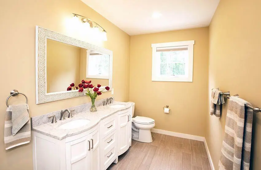 Bathroom with desert yellow paint and beige floor tile