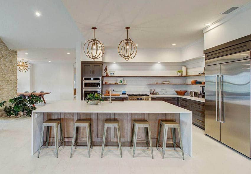 Contemporary style kitchen with waterfall quartz slab countertops, globe lighting, tile floors and wood grain cabinets