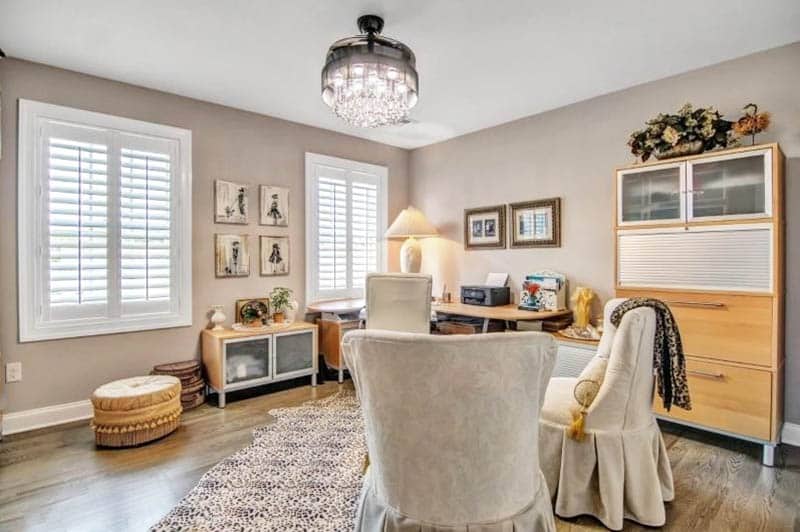 Room with light brown paint, plush comfy seating and plantation shutters