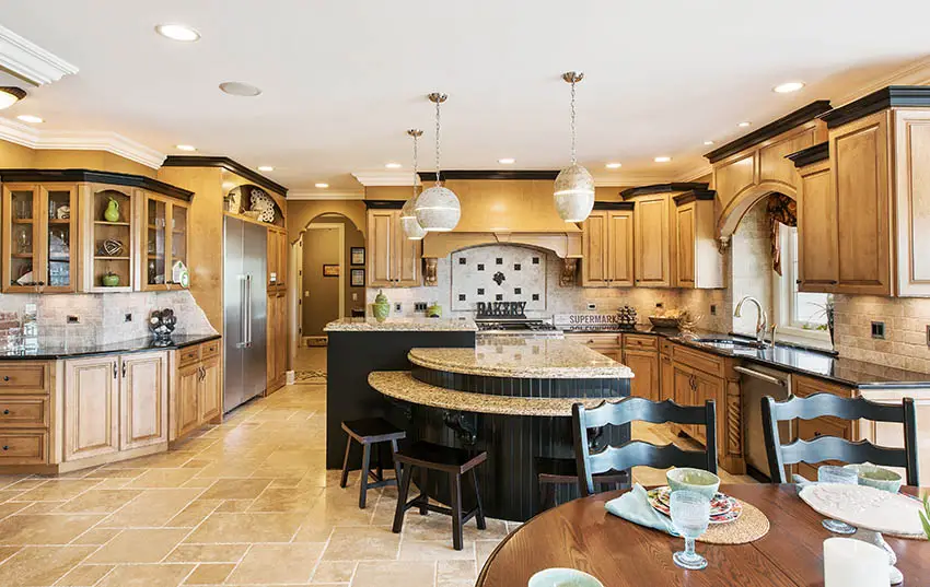 Expansive kitchen with raised panel cabinets, large multi level island and beige granite countertops