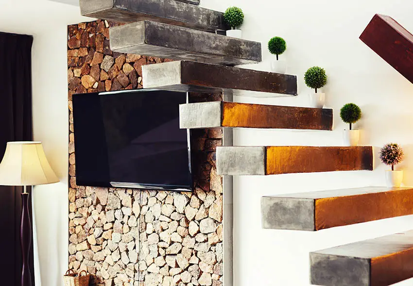 Concrete stairs with no railing with stacked stone accent wall