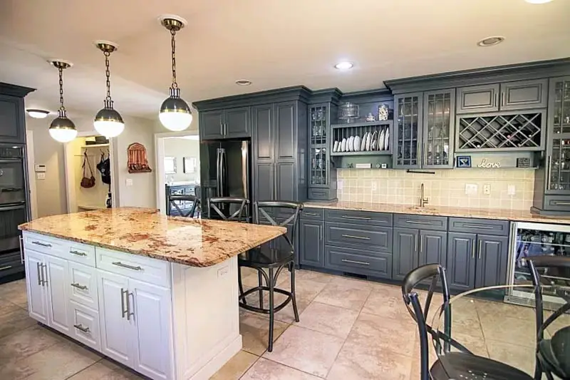 Kitchen with granite tiles, dark gray cabinets and white island