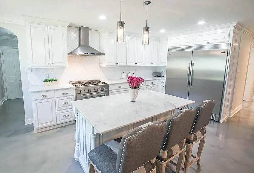 Kitchen with gray epoxy floors white cabinets marble countertops