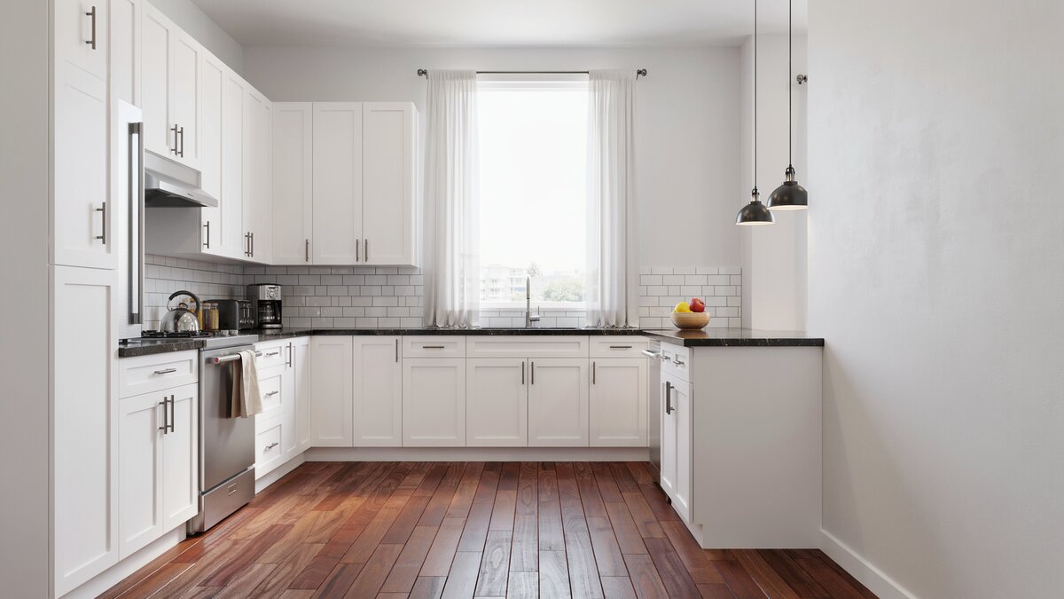 White shaker kitchen with black granite counters and reddish jatoba plank floor