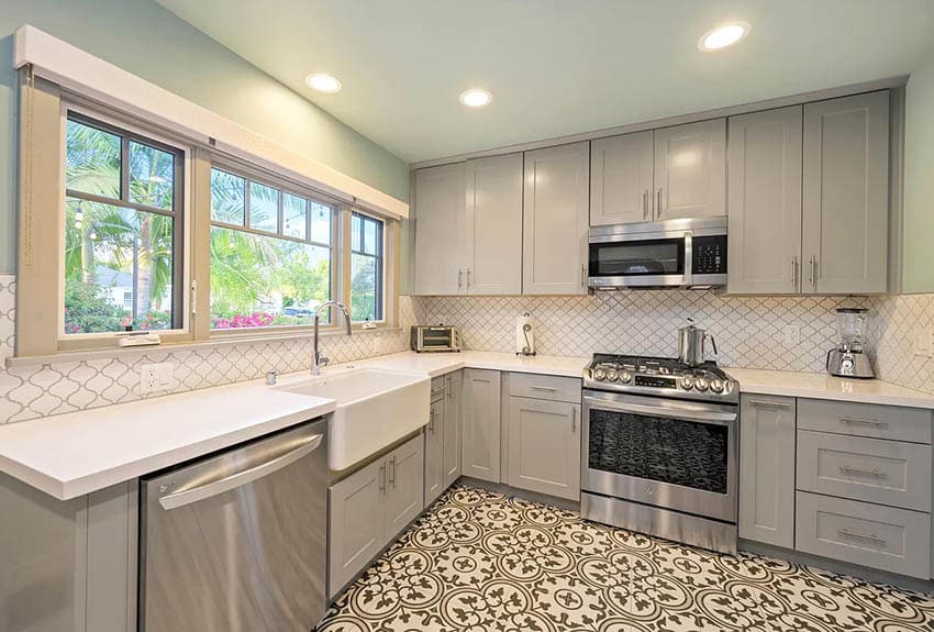 Kitchen with mosaic tile floors gray cabinets white countertops