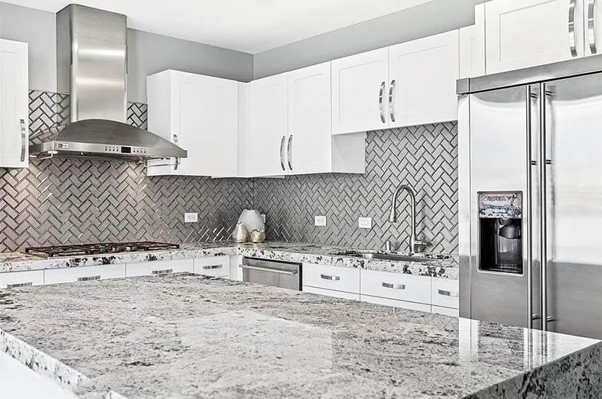 Metallic backsplash in herringbone pattern