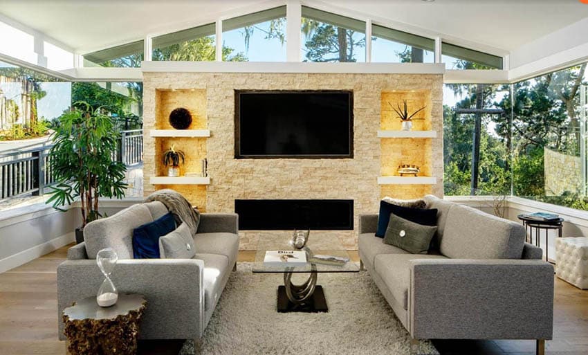 Living room with stacked stone accent wall with lighting and shelving