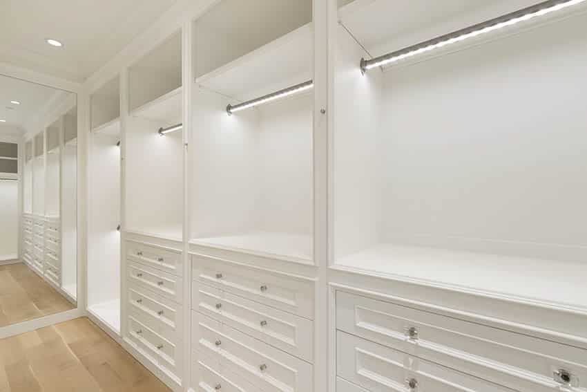 Closet with rod lighting, recessed lighting and drawers