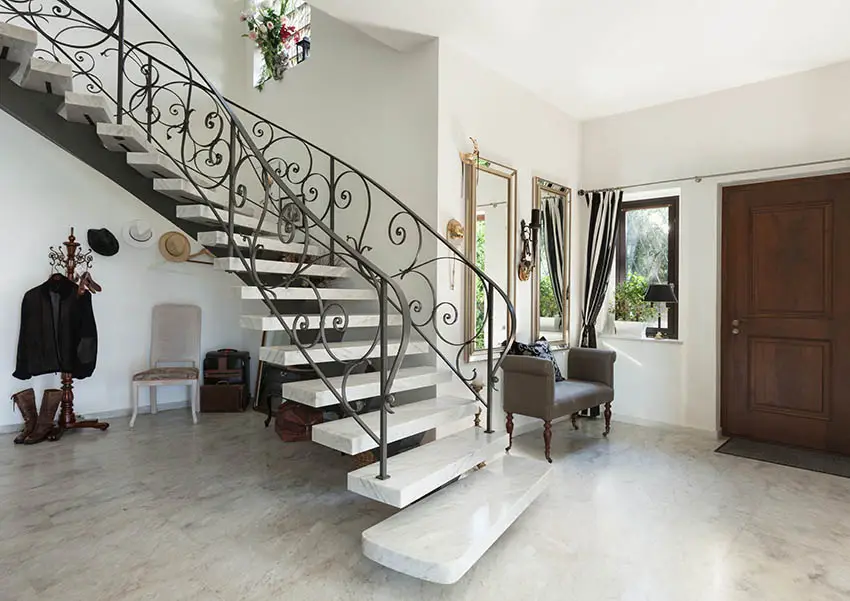 Stairs with marble steps and wrought iron hand railing