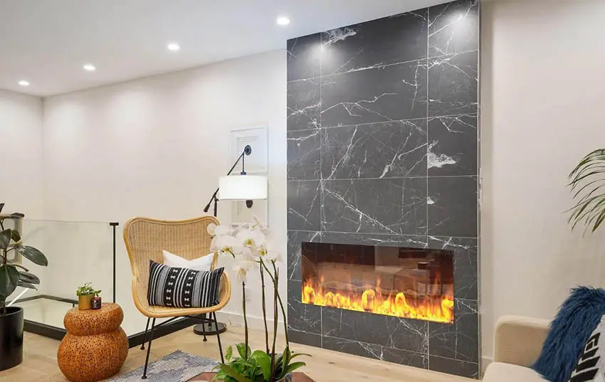 Modern electric fireplace with gray marble look tile surround