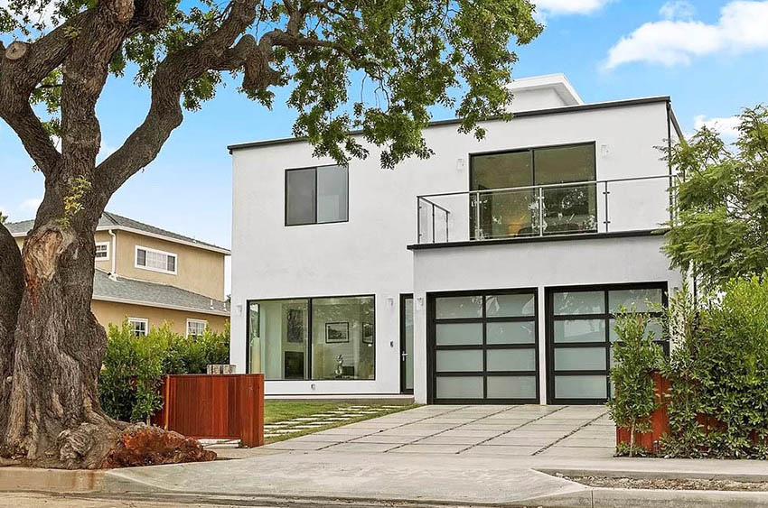 Home with balcony, picture windows and glass panel doors