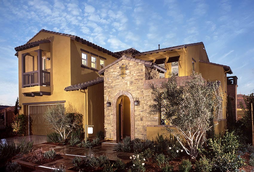 Stucco and stone house with balcony